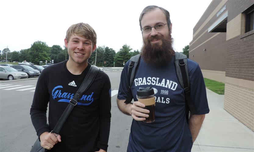 Two men smile